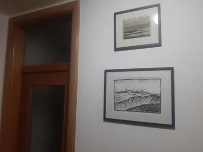 two framed pictures on a wall next to a door at Apartment No1 in Banja Luka