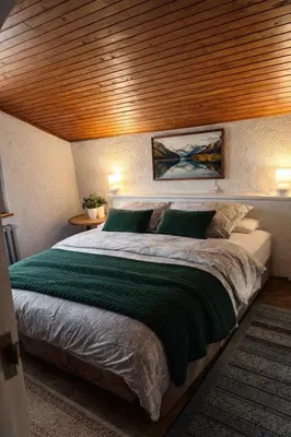 a bedroom with a large bed with a wooden headboard at Wooden house Tešanj in Tešanj
