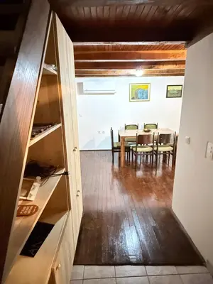 a kitchen and dining room with a table and chairs at Wooden house Tešanj in Tešanj