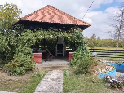 a small gazebo with a chair in it at Vikendica Brvnička Oaza mir i priroda kraj Šamca
