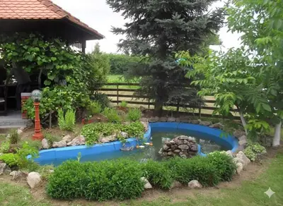 a garden with a pond in the yard at Vikendica Brvnička Oaza mir i priroda kraj Šamca