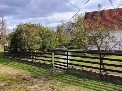 a black fence in front of a house at Vikendica Brvnička Oaza mir i priroda kraj Šamca