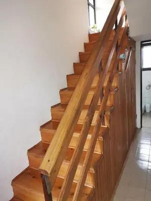 a wooden staircase with wooden railings in a house at Vikendica Brvnička Oaza mir i priroda kraj Šamca