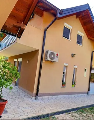 a house with a fan on the side of it at VA villa Tešanj in Tešanj