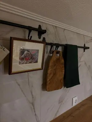 a towel rack with a picture on a wall at Apartman Slapovi in Banja Luka