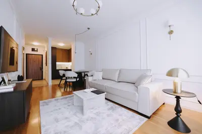 a living room with a white couch and a table at Park Residence - Luxury Parkside Apartment with Garage in Banja Luka