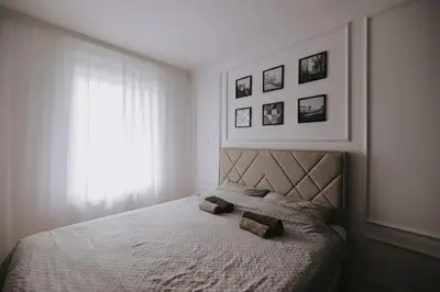 a bedroom with a bed with two pillows on it at Park Residence - Luxury Parkside Apartment with Garage in Banja Luka