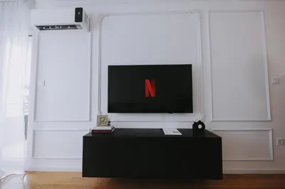 a tv sitting on top of a table in a room at Park Residence - Luxury Parkside Apartment with Garage in Banja Luka