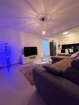 a living room with a couch and a tv at Real Comfort in Bugojno