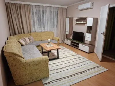 a living room with a couch and a table at Stan na dan Čaršija in Gračanica