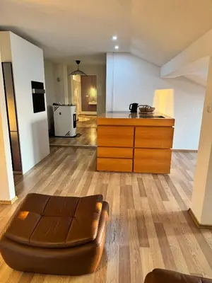 a living room with a couch and a kitchen at Amely in Bihać