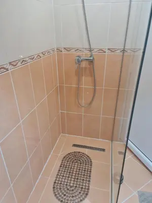a shower with a glass door with a shower head at Amely in Bihać