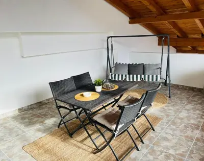 a table and chairs in a room with a bed at Amely in Bihać