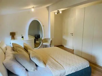 a bedroom with a bed with pillows and an archway at Amely in Bihać