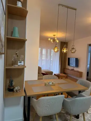 a dining room and living room with a table and chairs at D&Ana in Banja Luka