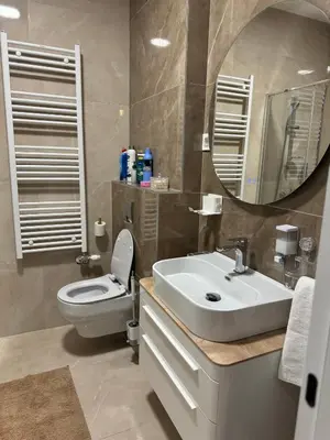 a bathroom with a toilet and a sink and a mirror at D&Ana in Banja Luka