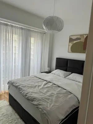 a bedroom with a large bed and a pendant light at D&Ana in Banja Luka