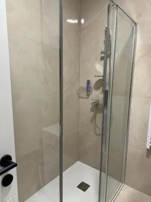 a shower with a glass door in a bathroom at D&Ana in Banja Luka