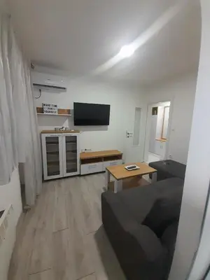a living room with a couch and a flat screen tv at Jagoda stan na dan in Prijedor