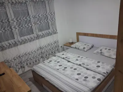 a bedroom with a bed and two pillows at Jagoda stan na dan in Prijedor