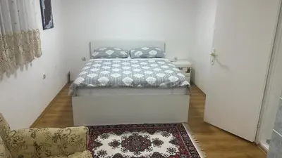 a bedroom with a bed and a couch and a rug at Arden House - Mountain Escape with Pool in Mali Radić