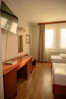 a hotel room with a desk and two beds at New Lake in Laktaši