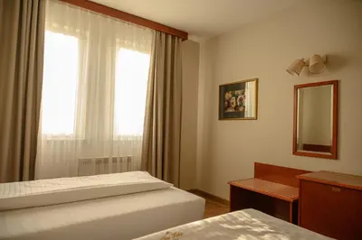 a hotel room with two beds and a window at New Lake in Laktaši