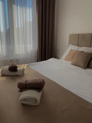 a bedroom with a bed with towels on it at Apartman Blagojević in Banja Luka