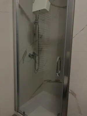 a shower with a glass door in a bathroom at Apartman Blagojević in Banja Luka