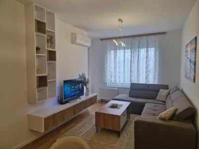 a living room with a couch and a tv at Stay & Enjoy Apartment in Banja Luka