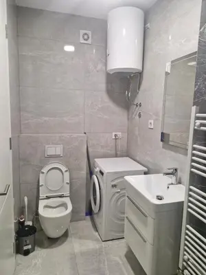 a small bathroom with a toilet and a sink at Stay & Enjoy Apartment in Banja Luka