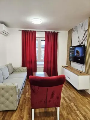 a living room with a couch and a tv and a chair at Apartment Dora 3 in Banja Luka