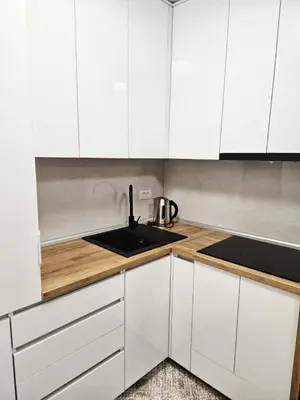 a kitchen with white cabinets and a sink at Apartment Dora 3 in Banja Luka