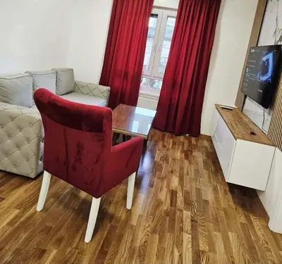 a living room with a couch and a table and a chair at Apartment Dora 3 in Banja Luka