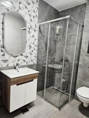 a bathroom with a shower and a sink and a toilet at Apartment Dora 3 in Banja Luka