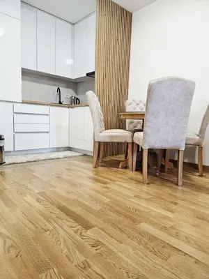 a kitchen with a dining room table and chairs at Apartment Dora 3 in Banja Luka