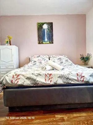 a bed sitting in a bedroom with avertisementatron at Rural accommodation Vidovic