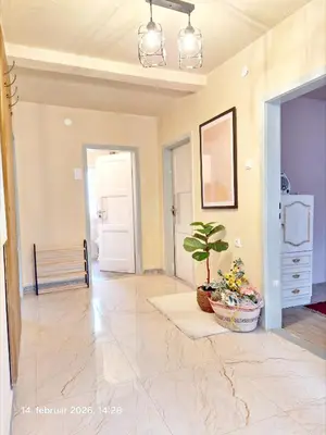 a living room with a potted plant and a hallway at Rural accommodation Vidovic