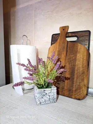 a table with a roll of toilet paper and purple flowers at Rural accommodation Vidovic