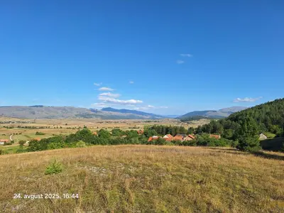 a view of a field with mountains in the background at Rural accommodation Vidovic