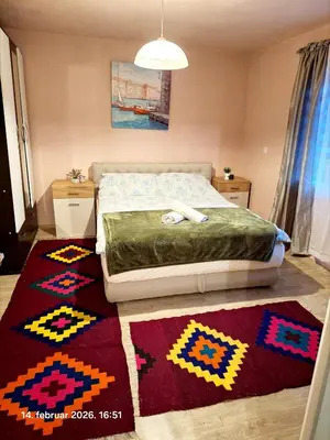 a bedroom with a bed with a colorful rug at Rural accommodation Vidovic