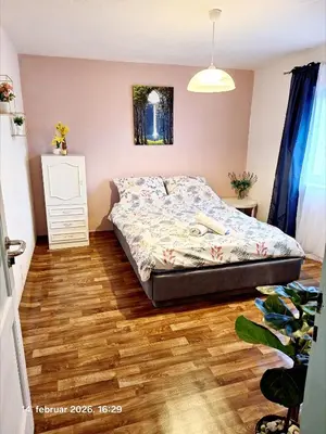 a bedroom with a bed and a wooden floor at Rural accommodation Vidovic