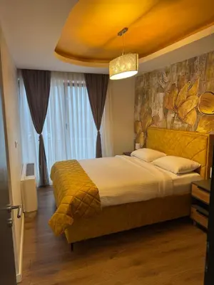 a bedroom with a large bed with a painting on the wall at Pansion Afitos in Laktaši