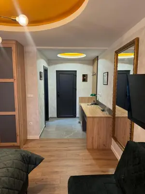 a bathroom with a large mirror and a sink at Pansion Afitos in Laktaši