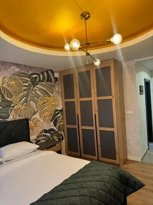 a bedroom with a bed and a glass cabinet at Pansion Afitos in Laktaši
