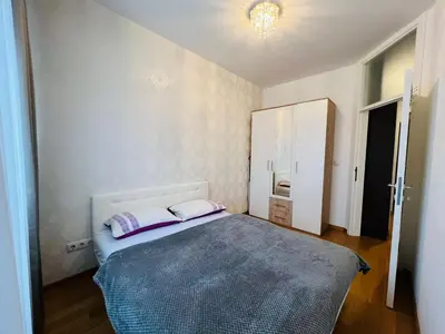 a bedroom with a bed with two pillows on it at Apartman Tara 23 in Banja Luka