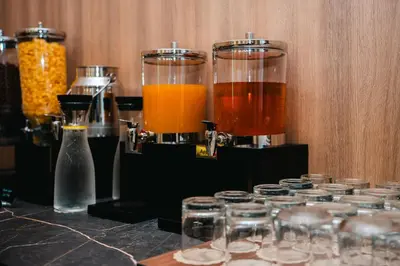 a group of different types of drinks in glass jars at Stars Hotel in Jelah