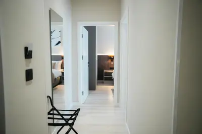 a hallway with a chair and a room with a bedroom at Stars Hotel in Jelah