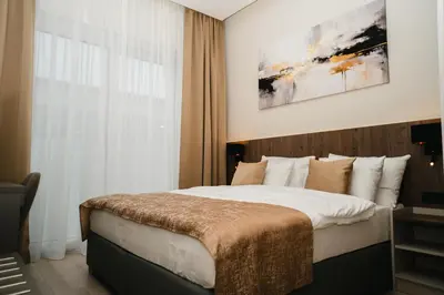 a bedroom with a large bed and a window at Stars Hotel in Jelah