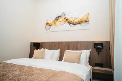 a bedroom with a bed and a painting on the wall at Stars Hotel in Jelah